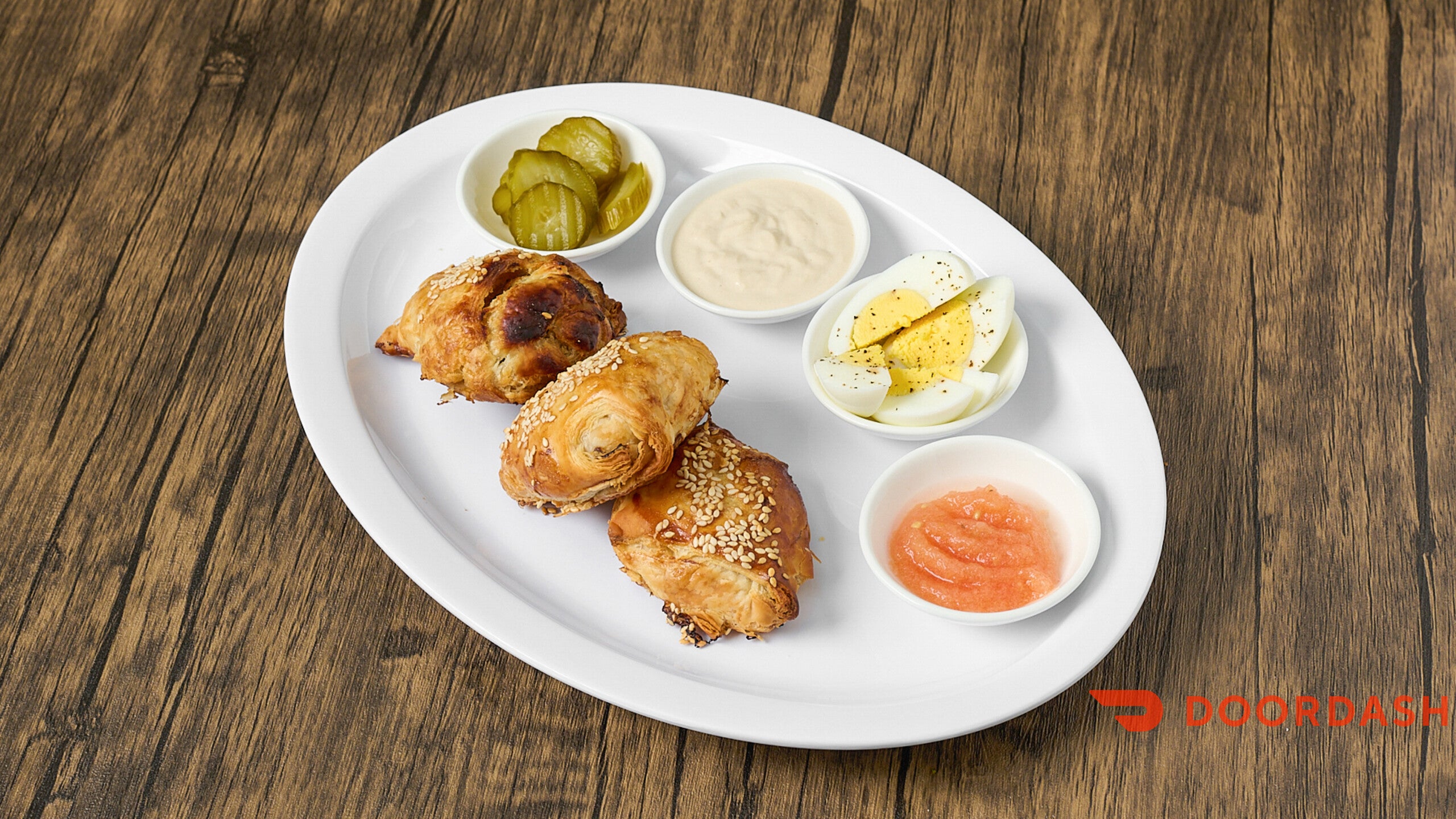 Platter of fried chicken with various dipping sauces on a wooden table